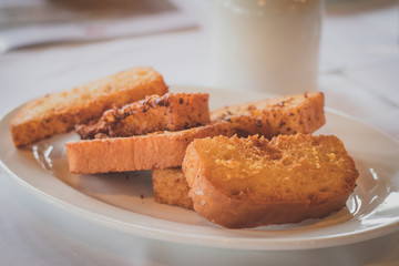 Slices of fried bread on a white plate. Common breakfast in certain parts of europe, also known as snite.