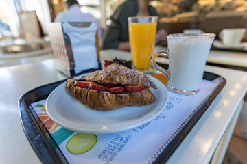 Croissant sandwich with straberries and chocolate