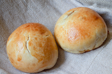 Baked bun on a linen fabric. Baked rolls.