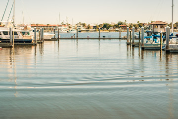 Water Rippling Between Rows of Boat Docks at City Marina