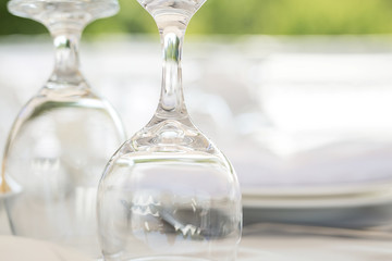 Wine glasses on a table outdoor. Focus blurred foreground, defocused background bokeh