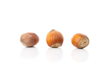 Close up of a three hazelnuts isolated over white background