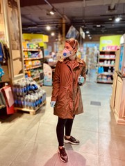 Fototapeta premium girl in a protective mask and gloves against coronavirus in a supermarket. beautiful young woman. grocery store. Russian girl. Covid-2019.