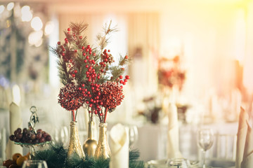 Decoration for the holiday table. Spruce branch and berries of viburnum.