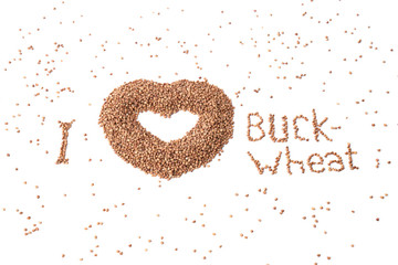 Heart-shaped bowl of roasted buckwheat on bwhite background. Gluten free and healthy diet. I love buckwheat concept