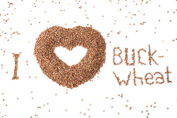 Image of a heart from buckwheat on a white background. favorite buckwheat. cereal in the form of a heart. top view of buckwheat.