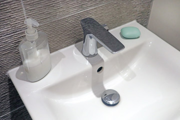 Sink with liquid soap and bar of soap