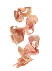 Fototapeta premium Set of flying cut delicious prosciutto on white background