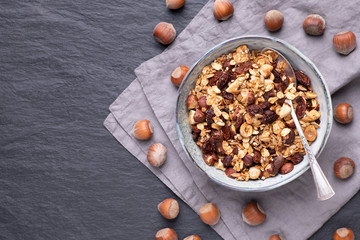 Homemade granola with nuts, raisins and seeds in bowls, good choice for breakfast or healthy snack