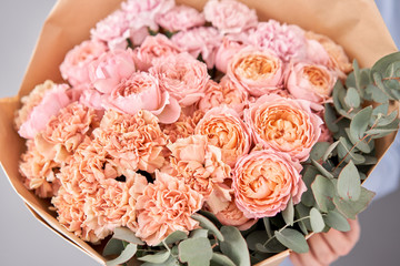 Flowers set in womans hands. Fresh cut flowers for decoration home. European floral shop. Beautiful bouquet of mixed flowers . Delivery fresh cut flower.