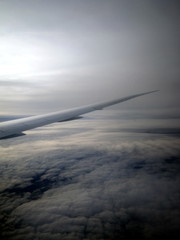 Fototapeta na wymiar Wing of an airplane with clouds