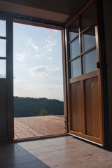 Open door with a view at a terrace and a beautiful landscape