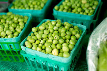 A view of several containers of sugar snap peas on display at a local farmers market.