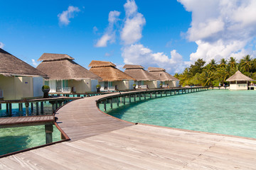 A view at the beach and waterhuts at tropical island, Maldives