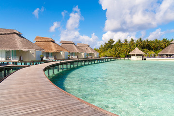 A view at the beach and waterhuts at tropical island, Maldives