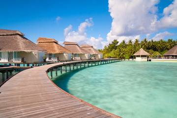 A view at the beach and waterhuts at tropical island, Maldives