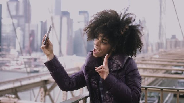 Adult Afro American female taking selfie on brooklyn bridge