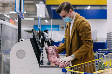 a man in a medical mask buys food at a grocery store. Coronavirus, virus, infection, epidemic, pandemic.  RUSSIA, RUSSIA-MARCH 19, 2020. OBNINSK