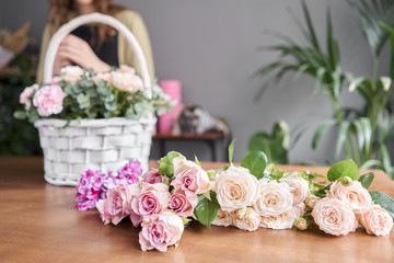 Education in the school of floristry. Master class on making bouquets. Summer bouquet in a wicker basket.. Learning flower arranging, making beautiful bouquets with your own hands. Flowers delivery