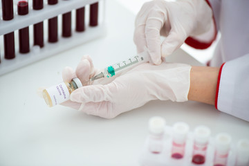 Test tubes with blood sample Covid-19 coronavirus. Vaccine and syringe injection It use for...