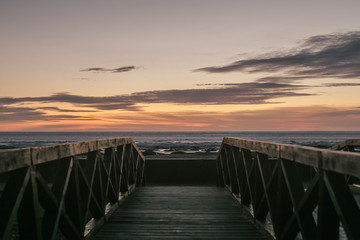 Fototapeta na wymiar sunset at sea wooden fence