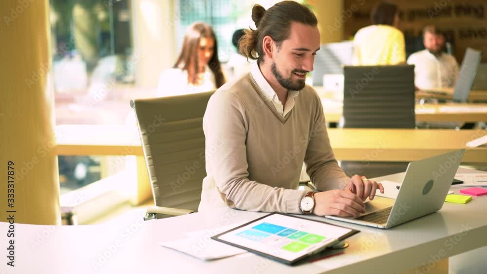 Poster caucasian freelancer working in modern coworking space using high speed internet connection on lapto