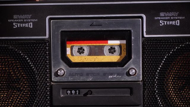 Yellow Audio Cassette in the Tape Recorder Playing and Rotates