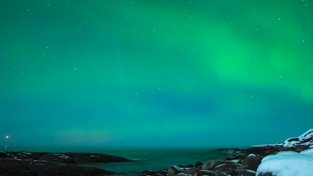 Northern Lights, polar light or Aurora Borealis in the night sky over the arctic landscape of Senja island in northern Norway. Time lapse video.