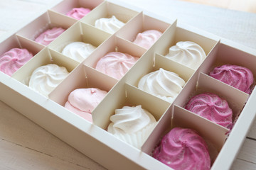 marshmallows in a box. Sweets on white background. Homemade marshmallows. Meringue, Zephyr.