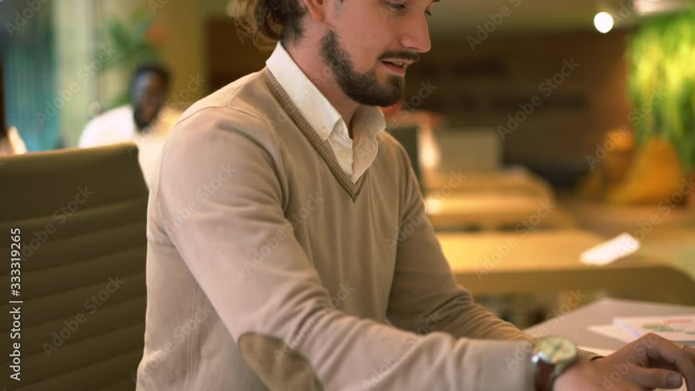 Poster caucasian software developer in smart casual wear using laptop internet for working with web project