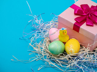 Easter conceptual picture with Easter eggs in a basketn and baby chicken. Easter conceptual picture