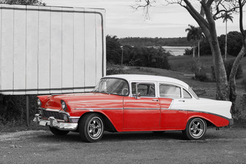 colorkey of classic red and white car on the road in vinales cuba