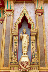 Golden standing Buddha statue.