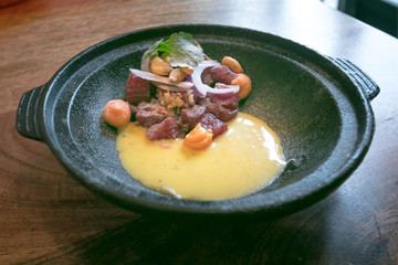 Close-up shot of delicious traditional raw salmon peruvian ceviche marinade with tiger milk (leche de Tigre)