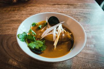 Yellow curry with cod fish, mussels, onion and white rice