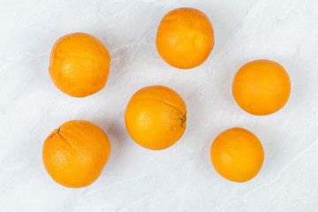 Flatlay above Raw Oranges on the grey marble table