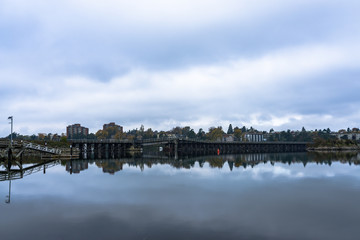 Fototapeta premium Reflections of the Selkirk Trestle Bridge in Victoria on Water Like Glass