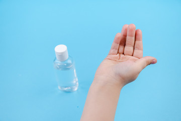 Hand cleaning gel. Pouring sanitising hand gel onto the child's hand