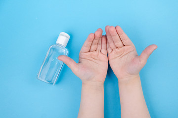 Hand cleaning gel. Pouring sanitising hand gel onto the child's hand