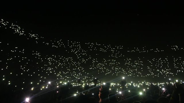 Phone lights at concert in a stadium