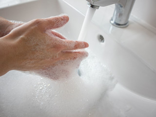 young person washing hands rubbing with soap for covid-19 epidemic prevention.