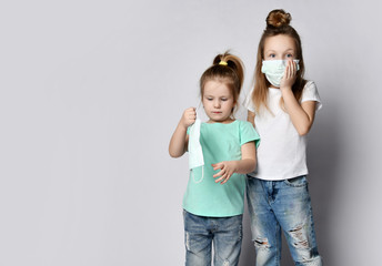 Two children girls kids are afraid of the disease in protection masks from the Coronavirus Covid-19 