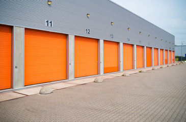 small business units with orange roller doors