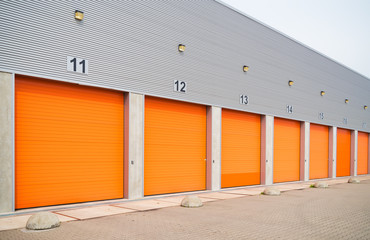 Fototapeta na wymiar small business units with orange roller doors