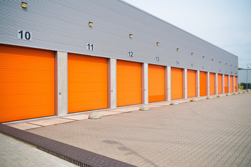 small business units with orange roller doors