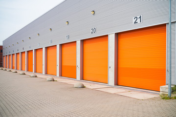 small business units with orange roller doors