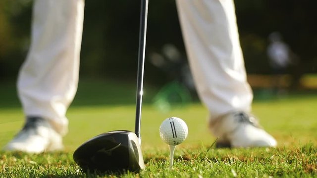 Golfer striking a ball close up