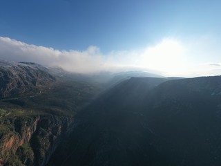 Aerial view of mountains at sunrise, Morning fog over mountains, Sun beams