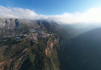 Aerial view of Delphi, Greece at sunrise, the Gulf of Corinth, Morning fog over mountains,...