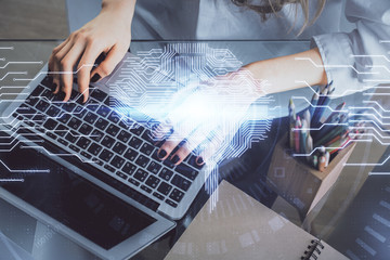 Double exposure of woman hands working on computer and brain hologram drawing. Ai concept.